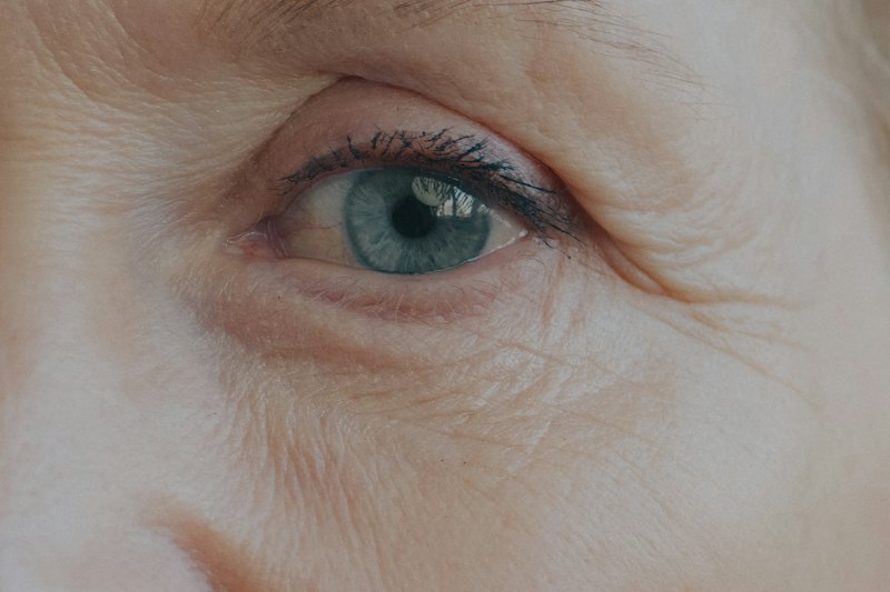 Close-up of mature skin around the eye, showing fine lines and natural texture